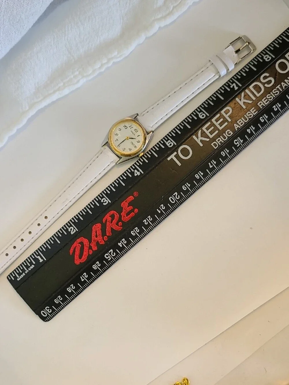 Seiko White Dial Watch with Gold Bezel and White Strap